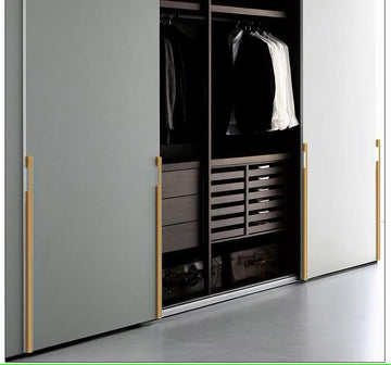 Extra-long modern aluminum cabinet handle in matte black and gold finish on wardrobe door