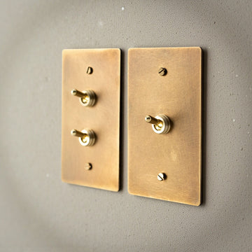 Aged brass toggle light switch plate in retro style”

“Solid brass dimmer switch with vintage finish”

“Retro multi-gang brass toggle switch panel”

“Aged brass electrical wall switch for home interiors”